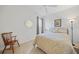 Cozy bedroom features a bed, chair, and a large round decorative mirror at 4004 Landor Ct, Venice, FL 34293