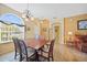 Bright dining room featuring wood flooring, a large window, and a lovely chandelier above the dining table at 4004 Landor Ct, Venice, FL 34293