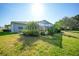 Well-maintained home featuring a large backyard, lush landscaping, and a screened lanai at 4004 Landor Ct, Venice, FL 34293