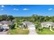Inviting home with lush greenery, mature palms, and a pristine lawn leading to a two-car garage at 4004 Landor Ct, Venice, FL 34293