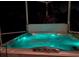 A bubbling hot tub sits on an outdoor patio at night at 4004 Landor Ct, Venice, FL 34293