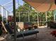 Relaxing screened-in lanai featuring a lounge chair, hot tub, and beautiful landscaping at 4004 Landor Ct, Venice, FL 34293