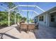 Comfortable lanai with a large table, chairs, and a relaxing view of the yard at 4004 Landor Ct, Venice, FL 34293