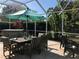 Inviting lanai with an outdoor dining set and umbrella, perfect for entertaining guests at 4004 Landor Ct, Venice, FL 34293