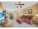 Inviting living room with cozy seating, decorative lamps, and access to adjacent dining and kitchen areas at 4004 Landor Ct, Venice, FL 34293