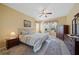 Warm, inviting main bedroom with carpet, a ceiling fan, and great natural light at 4004 Landor Ct, Venice, FL 34293