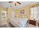 Cozy main bedroom with a ceiling fan and a glimpse into the en suite bathroom at 4004 Landor Ct, Venice, FL 34293