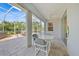 Covered patio with screened enclosure, furniture and ceiling fan at 4004 Landor Ct, Venice, FL 34293