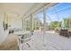 Covered patio with screened enclosure, furniture and hot tub at 4004 Landor Ct, Venice, FL 34293