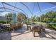 Large screened-in patio with outdoor furniture, creating an inviting space for relaxation and dining at 4004 Landor Ct, Venice, FL 34293