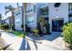 Condo exterior with lush tropical landscaping in front of a charming two-story building at 4410 Warren Ave # 306, Port Charlotte, FL 33953