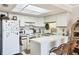 Functional kitchen with ample counter space, white cabinetry, and breakfast bar seating at 4410 Warren Ave # 306, Port Charlotte, FL 33953