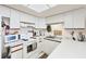 Efficient kitchen featuring bright lighting, essential appliances, and ample counter space for food prep at 4410 Warren Ave # 306, Port Charlotte, FL 33953