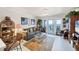 Cozy living room featuring comfortable seating, stylish decor, and sliding doors to a balcony at 4410 Warren Ave # 306, Port Charlotte, FL 33953