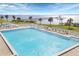 Stunning waterfront pool area with ample seating, lush landscaping, and a view of the ocean at 4410 Warren Ave # 306, Port Charlotte, FL 33953