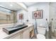 Elegant bathroom featuring a glass vessel sink and a tiled walk-in shower at 5000 Gasparilla Rd # 23A, Boca Grande, FL 33921