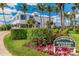 Stunning white clubhouse featuring manicured landscaping, a fountain, and a restaurant and lounge sign at 5000 Gasparilla Rd # 23A, Boca Grande, FL 33921