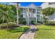 Charming two-story condo with lush landscaping and a welcoming brick path to the entrance at 5000 Gasparilla Rd # 23A, Boca Grande, FL 33921