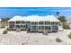 Stunning beachfront home boasting modern architecture, with a crisp white exterior and multiple balconies at 5000 Gasparilla Rd # 23A, Boca Grande, FL 33921