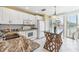 Well-lit kitchen featuring marble countertops, white cabinetry, and a distinctive island with woven details at 5000 Gasparilla Rd # 23A, Boca Grande, FL 33921