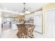 Open kitchen with white cabinetry, modern appliances, and an island with a decorative, woven base at 5000 Gasparilla Rd # 23A, Boca Grande, FL 33921