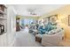Bright living room with large windows offering stunning ocean views and coastal-themed decor at 5000 Gasparilla Rd # 23A, Boca Grande, FL 33921