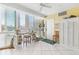 Bright, sunny room with large windows, tiled floors, and a cozy nook by the windows at 5000 Gasparilla Rd # 23A, Boca Grande, FL 33921