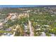 Aerial shot of residential neighborhood featuring mature trees lining the street, blending urban and natural elements at 521 Artists Ave, Englewood, FL 34223