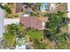 Overhead view of the house showing the roof, driveway, and surrounding trees and yard at 521 Artists Ave, Englewood, FL 34223