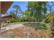 Spacious backyard featuring green grass, mature trees, and a privacy fence at 521 Artists Ave, Englewood, FL 34223