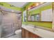 Bright bathroom with a tiled shower, ample counter space, and a large mirror at 521 Artists Ave, Englewood, FL 34223