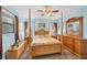 Comfortable bedroom featuring a four-poster bed, ceiling fan and ample wooden furniture at 521 Artists Ave, Englewood, FL 34223
