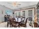 A view of the dining room featuring a wooden dining set, ceiling fan, and view of outdoor patio at 521 Artists Ave, Englewood, FL 34223