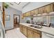A view of the kitchen featuring a stainless-steel sink, white countertops, and wood cabinets at 521 Artists Ave, Englewood, FL 34223