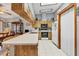 A view of the kitchen featuring a skylight, wood cabinets, white countertops and tile floors at 521 Artists Ave, Englewood, FL 34223