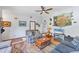 Cozy living room featuring wood flooring and a large TV for entertainment at 521 Artists Ave, Englewood, FL 34223
