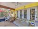 Covered patio with comfortable seating and a view of the landscaped backyard at 521 Artists Ave, Englewood, FL 34223