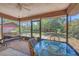 Relaxing screened patio with a dining table, chairs, and views of the garden at 521 Artists Ave, Englewood, FL 34223