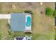 Aerial view of the property with a screened-in pool and manicured lawn at 642 Boundary Blvd, Rotonda West, FL 33947