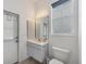 Well-lit bathroom showcasing a single vanity, toilet, and a window with natural light at 642 Boundary Blvd, Rotonda West, FL 33947