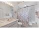 Bathroom featuring a vanity, toilet, and shower-tub combination with a decorative curtain at 642 Boundary Blvd, Rotonda West, FL 33947