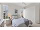 Bright bedroom featuring large windows, a ceiling fan, and neutral decor at 642 Boundary Blvd, Rotonda West, FL 33947