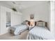 Charming bedroom with two twin beds and natural light coming from the window at 642 Boundary Blvd, Rotonda West, FL 33947