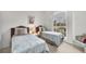 Bedroom with two twin beds featuring an abundance of natural light from the large picture window at 642 Boundary Blvd, Rotonda West, FL 33947
