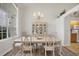 Formal dining room features a decorative chandelier, large window, and a china cabinet at 642 Boundary Blvd, Rotonda West, FL 33947