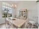 Formal dining room features a large window, decorative chandelier, and a light-colored china cabinet at 642 Boundary Blvd, Rotonda West, FL 33947