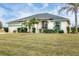 Attractive single-story home featuring mature landscaping and a well-kept lawn, creating an inviting curb appeal at 642 Boundary Blvd, Rotonda West, FL 33947