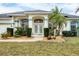 Elegant front entrance with double doors, arched windows, and manicured landscaping, creating an inviting entry at 642 Boundary Blvd, Rotonda West, FL 33947