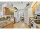 Bright kitchen with granite countertops, wood cabinets, tile floors, and adjacent dining area at 642 Boundary Blvd, Rotonda West, FL 33947