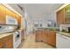 Well-lit kitchen featuring tile flooring, granite countertops, and light wood cabinetry at 642 Boundary Blvd, Rotonda West, FL 33947
